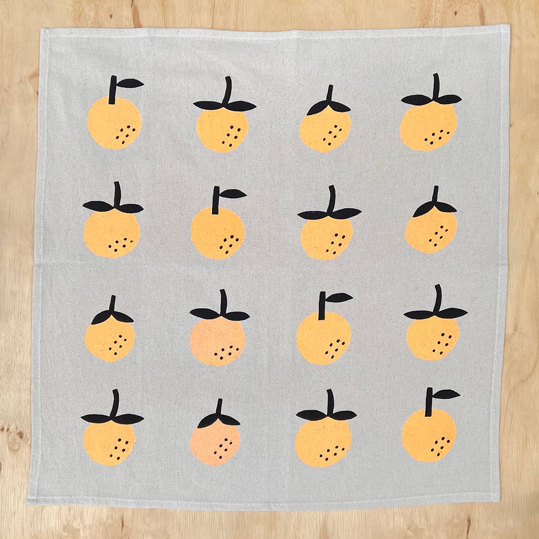 Linen tea towel with oranges screen printed on it