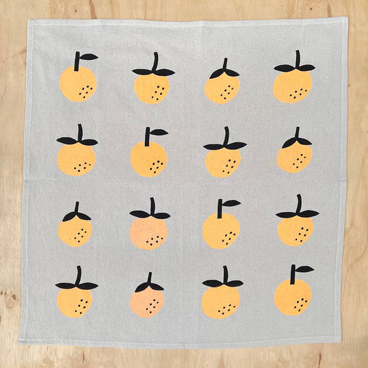 Linen tea towel with oranges screen printed on it