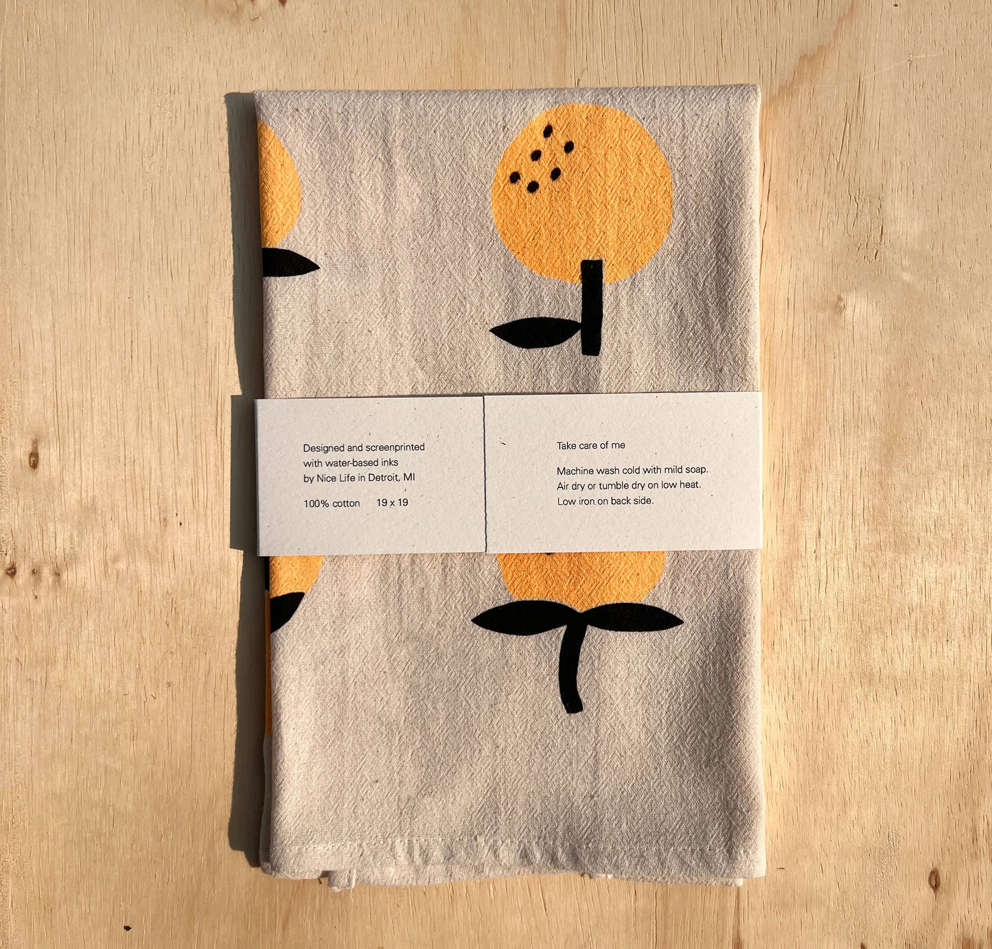 Linen tea towel with oranges screen printed on it
