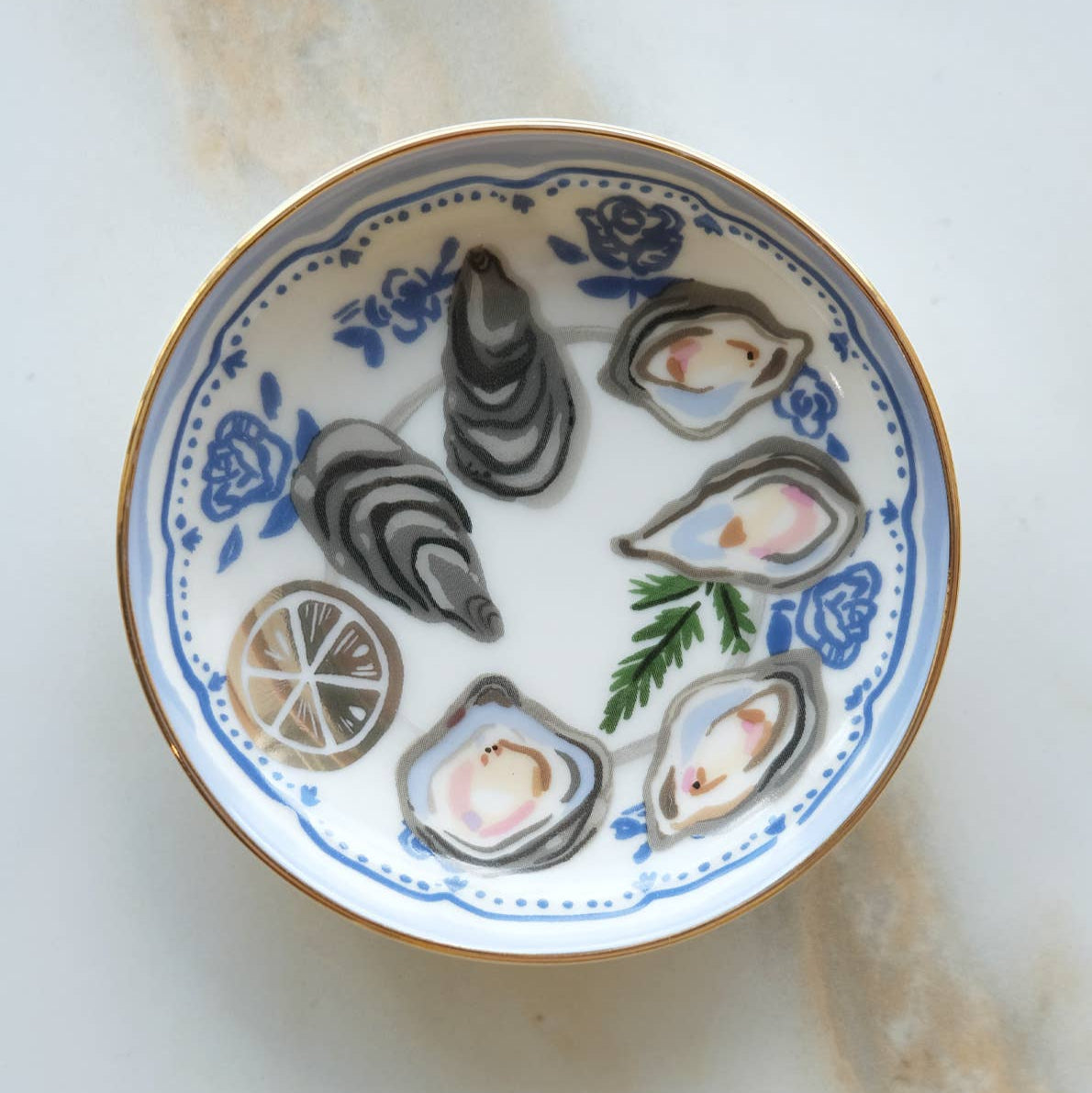 Decorative plate with oyster shells and lemon slices on a white background