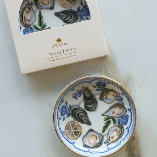 Decorative trinket dish with oyster design on a marble surface