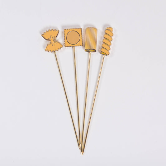 Four pasta themed cocktail picks with different shapes on a white background