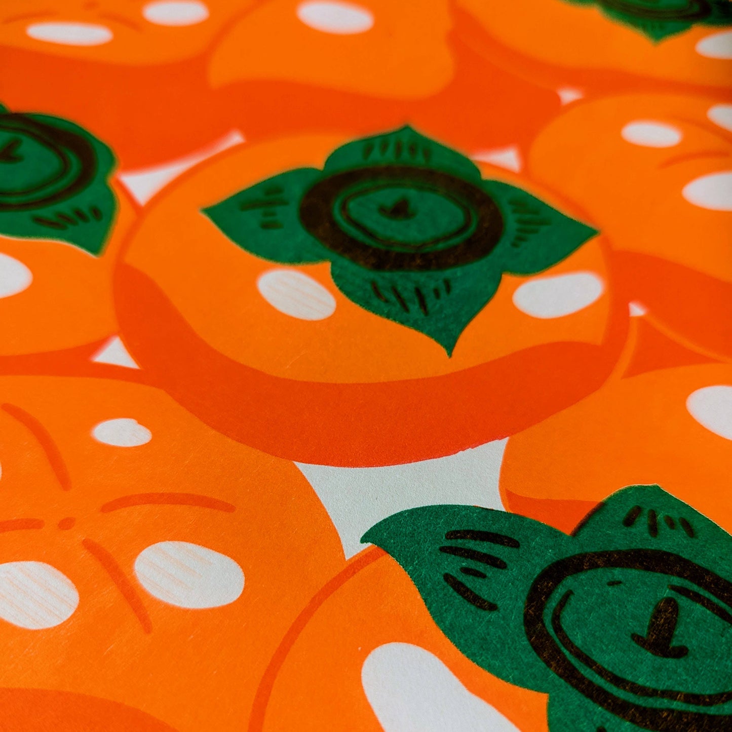 Pattern of orange persimmons with green leaves on a white background