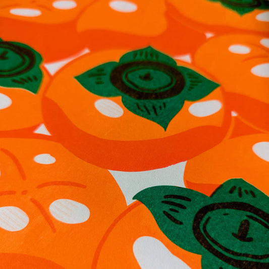 Pattern of orange persimmons with green leaves on a white background