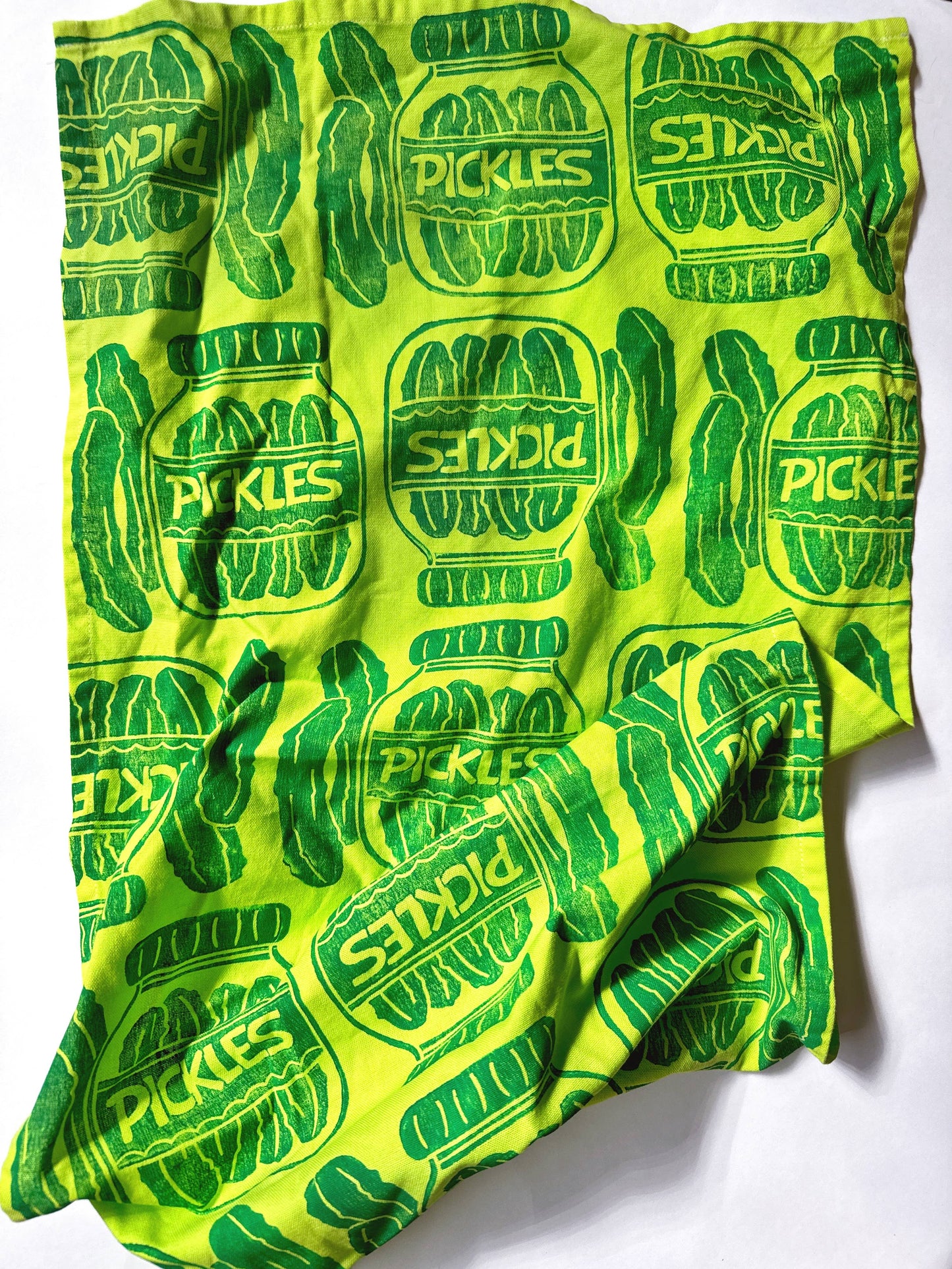lime green kitchen towel with a repeated pattern of jars of pickles printed in dark green ink