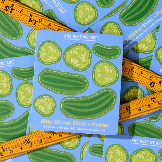 Sticker sheet with pickle design surrounded by rulers on a blue background