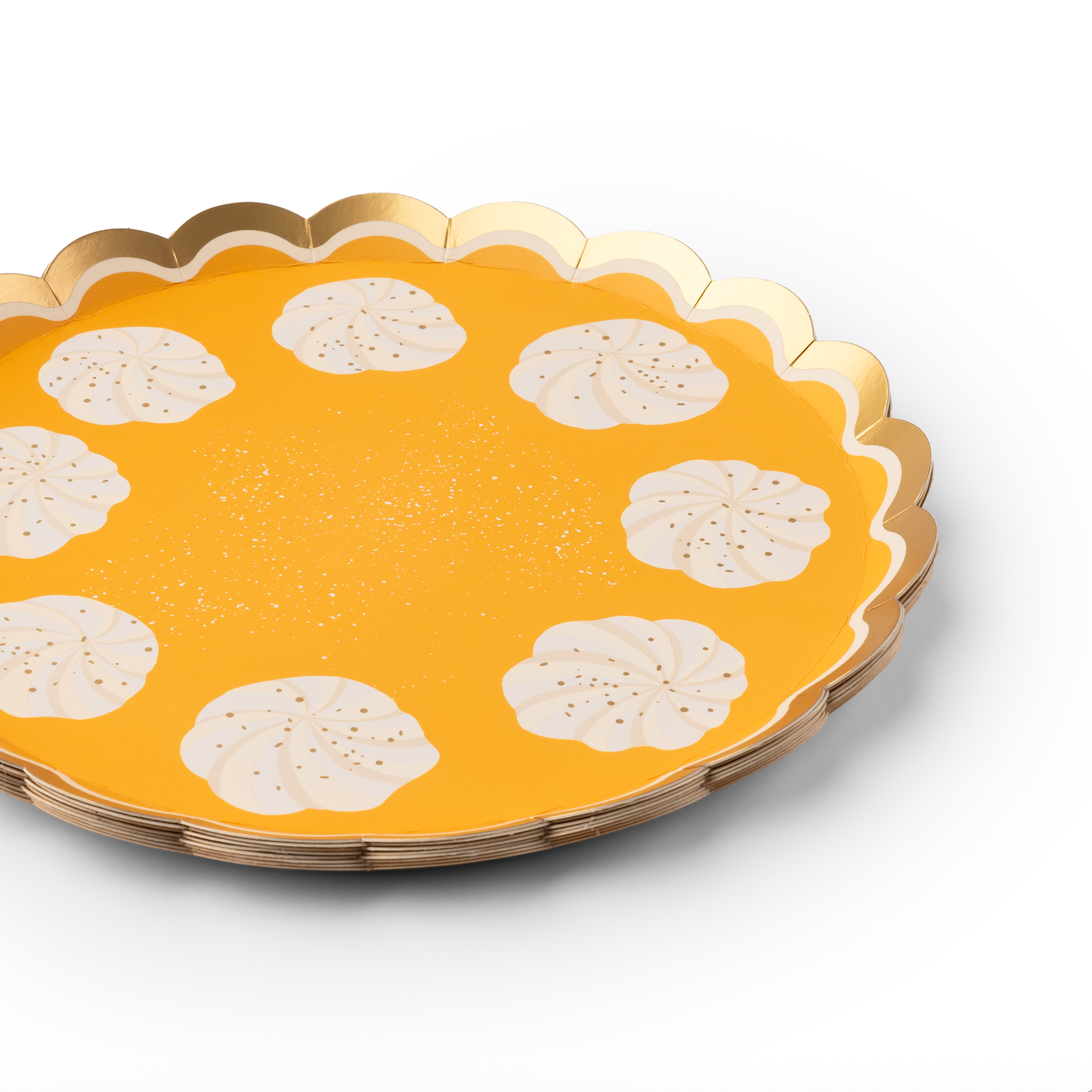 Yellow orange paper plate with scalloped edge and white whipped cream design on a white background