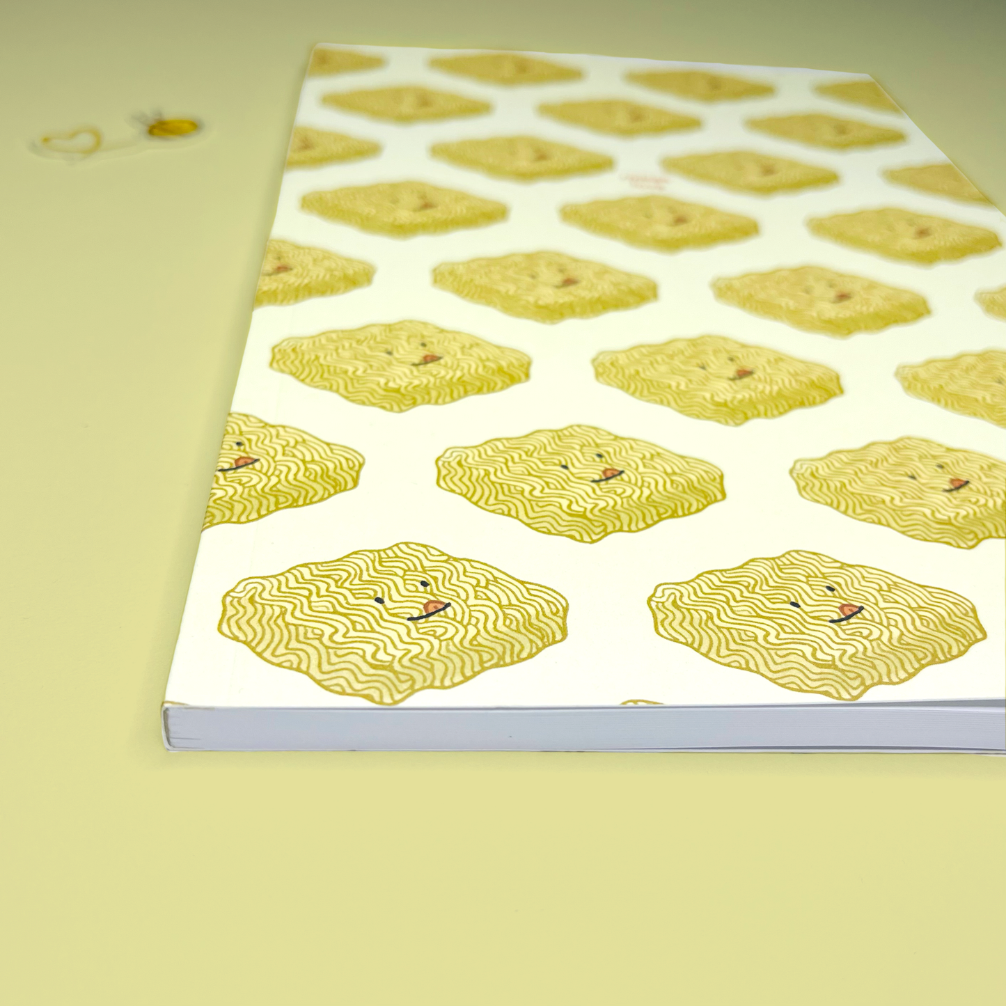 Notebook with yellow noodle pattern on a light yellow background