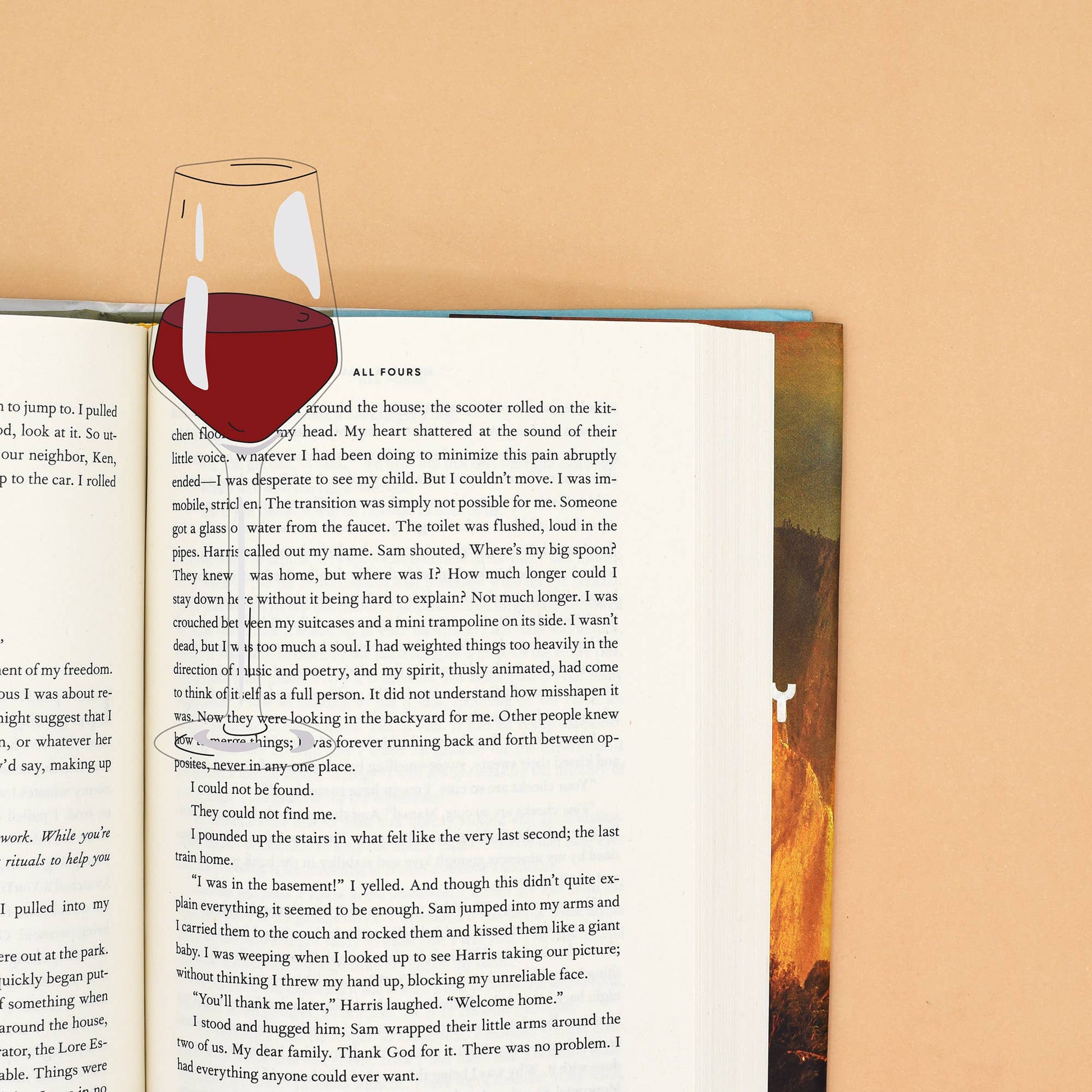glass of red wine bookmark inside book