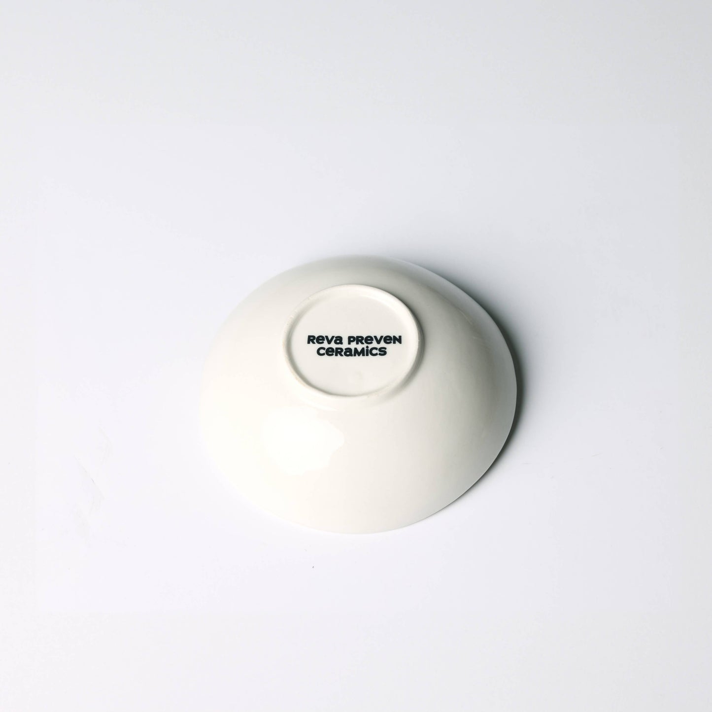 White ceramic bowl with a visible brand logo on a white background