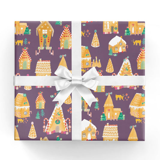 holiday gift wrap sheet that has festive gingerbread houses and trees on it