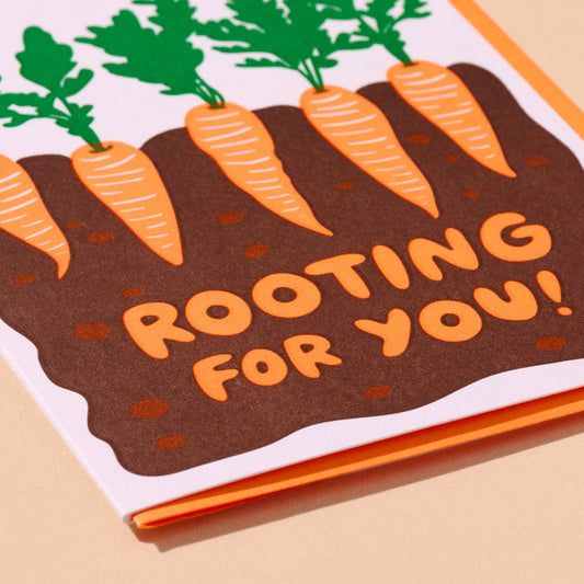 Card with illustrated carrots and 'Rooting for You!' text on a beige background