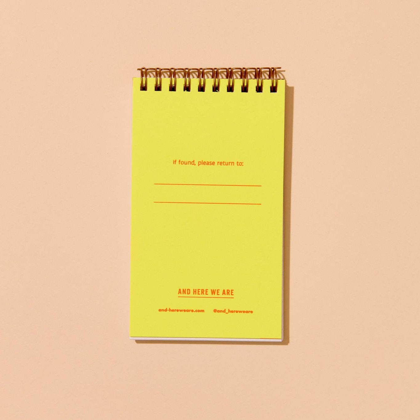 interior flap of shrimp pocket notebook. Has a yellow background with red text that reads "If found, please return to:" along with brand name at bottom