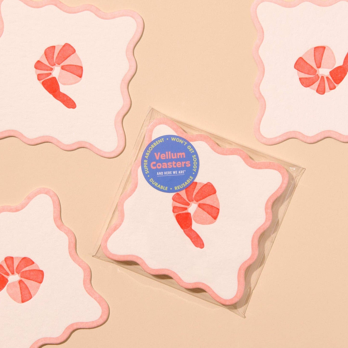 Vellum coasters with shrimp design on a beige background