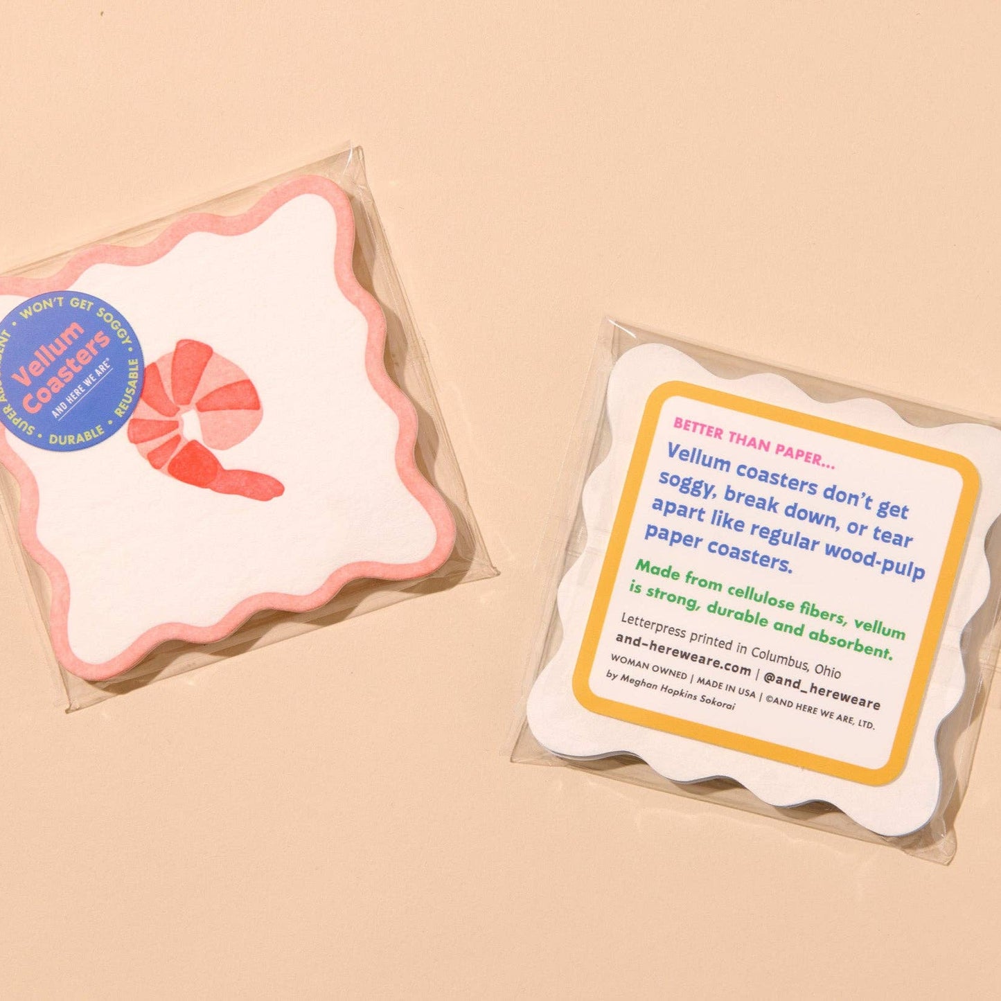 Two packages of shrimp vellum coasters on a beige background