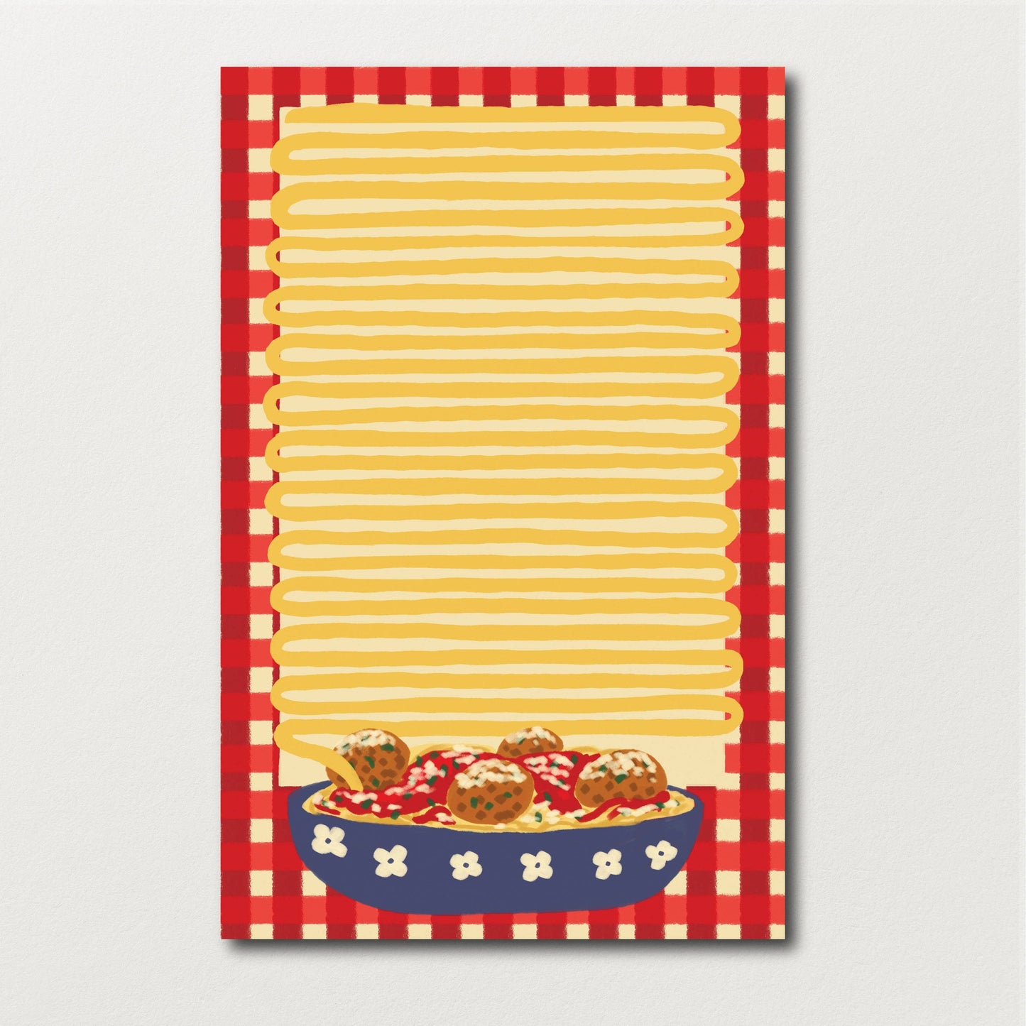 Spaghetti and meatball themed notepad. Has a bowl of spaghetti and meatballs at the bottom, notepad has a red gingham print with yellow lines in center, resembling a long pasta noodle