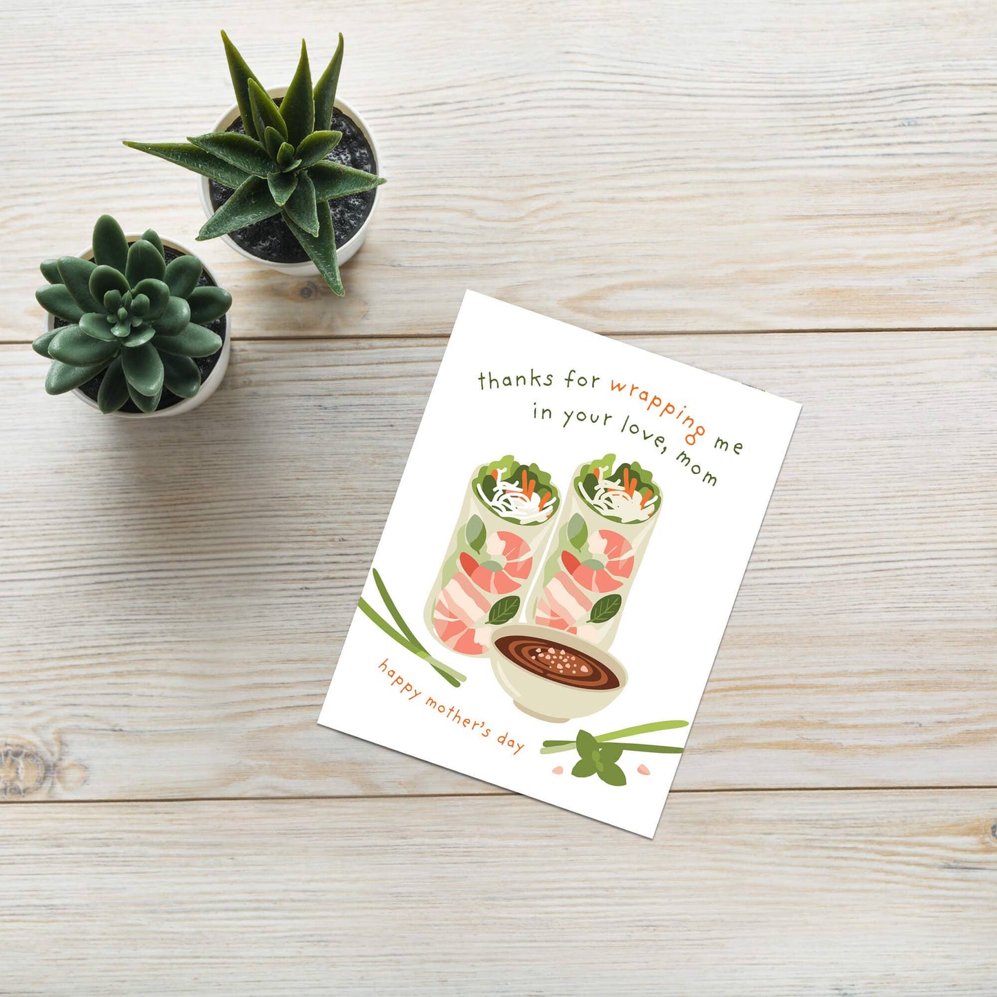 Greeting card with food illustration on a wooden surface with small plants.