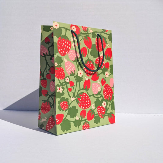 Gift bag with strawberry pattern on a white background