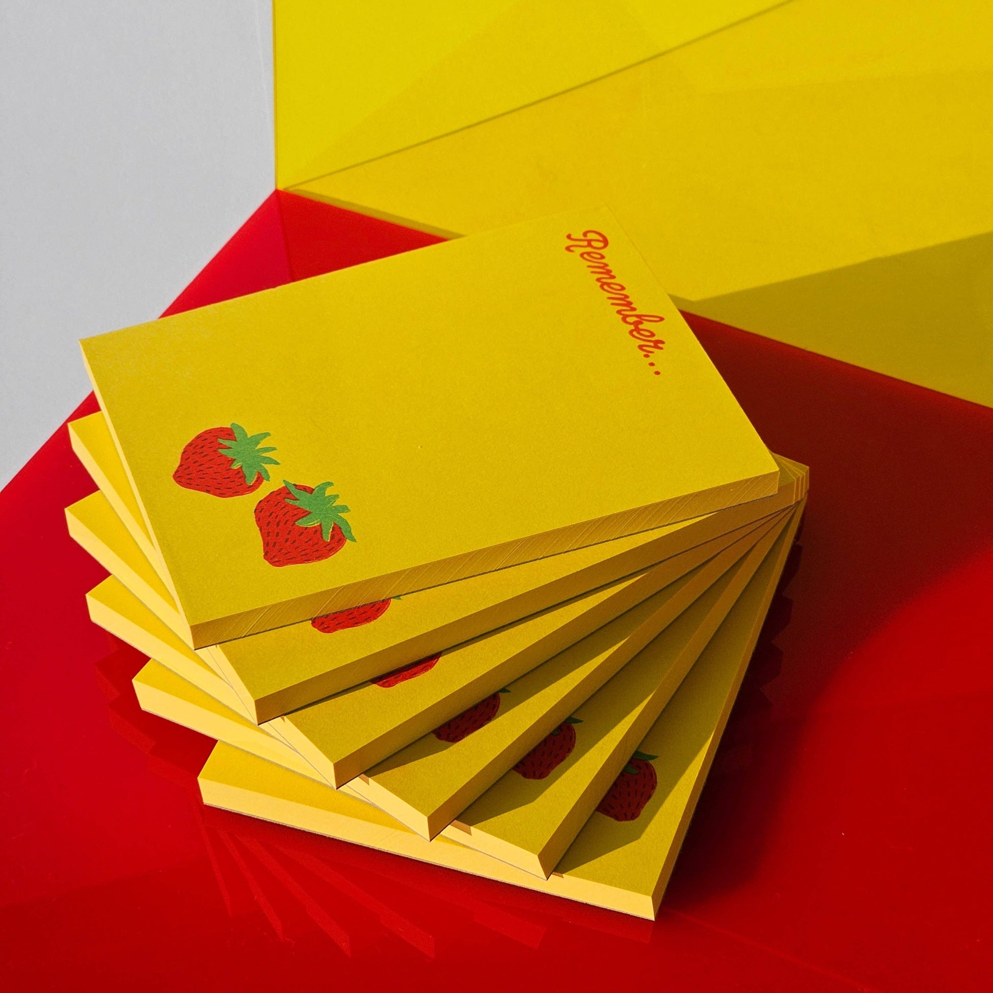 Above view image of 6 strawberry notepads stacked on top of each other
