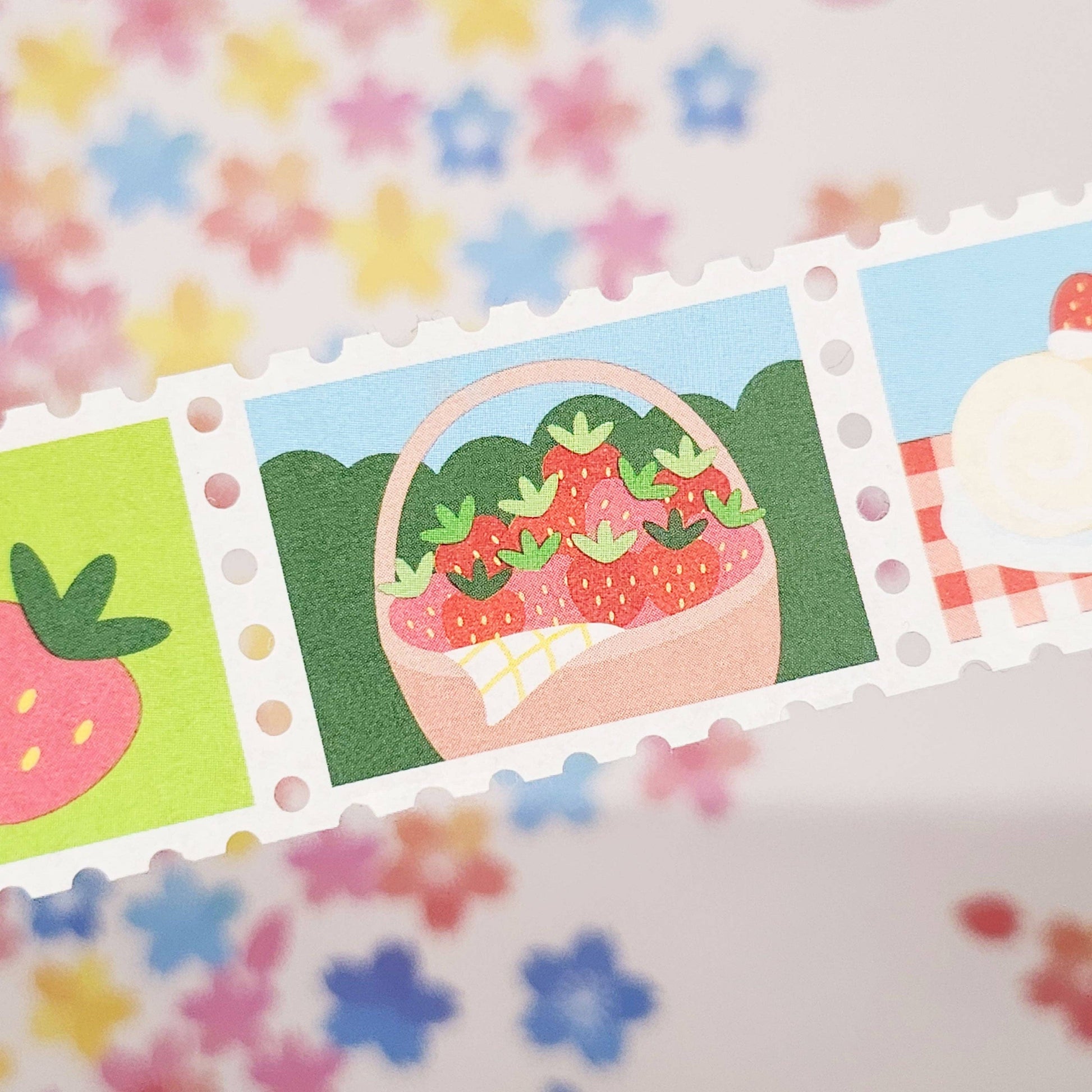 Set of colorful strawberry-themed washi stamps with a floral background