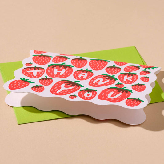 Scalloped edge thank you card with strawberry design on a beige background