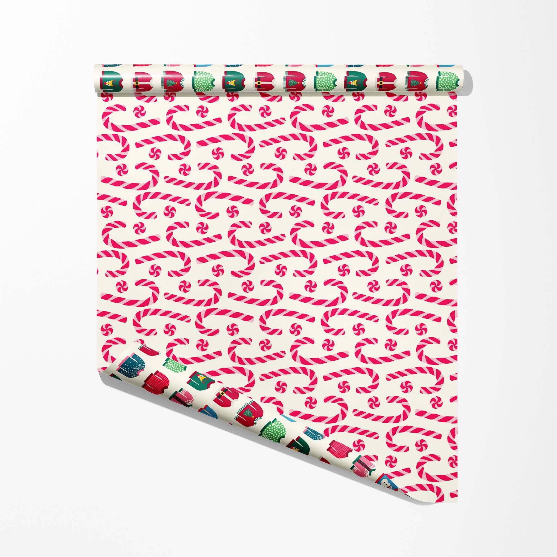Single sheet of double sided gift wrap -- one side has a peppermint candy/candy cane design and the other has ugly holiday sweaters on them