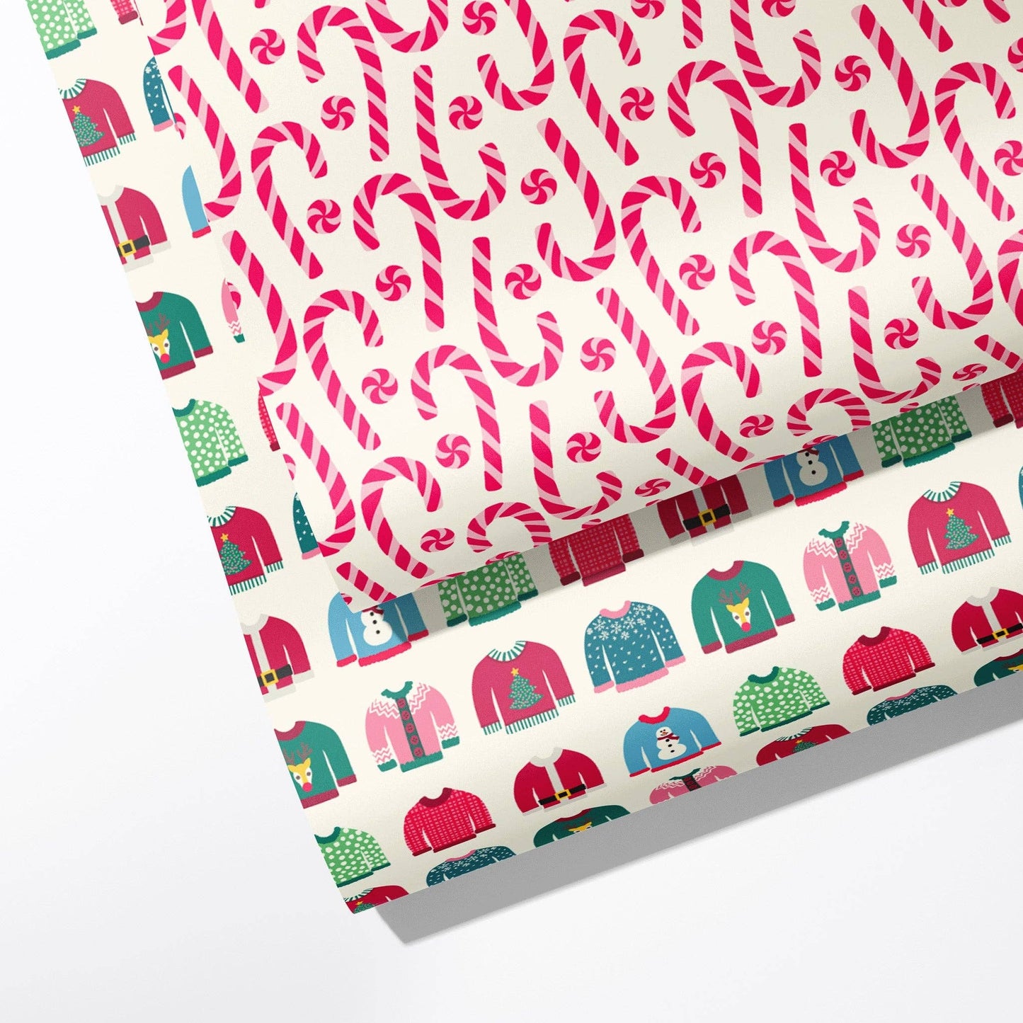 Single sheet of double sided gift wrap -- one side has a peppermint candy/candy cane design and the other has ugly holiday sweaters on them