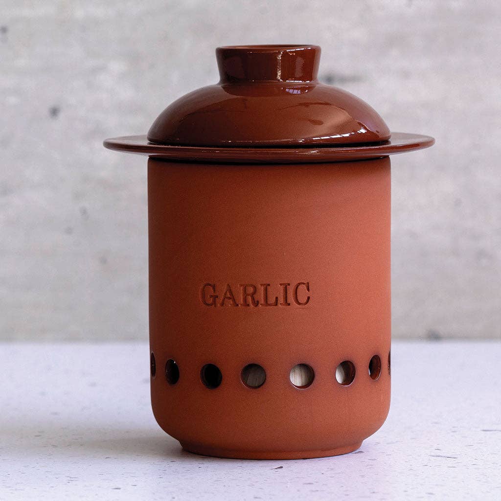 Ceramic garlic keeper with lid on a light background