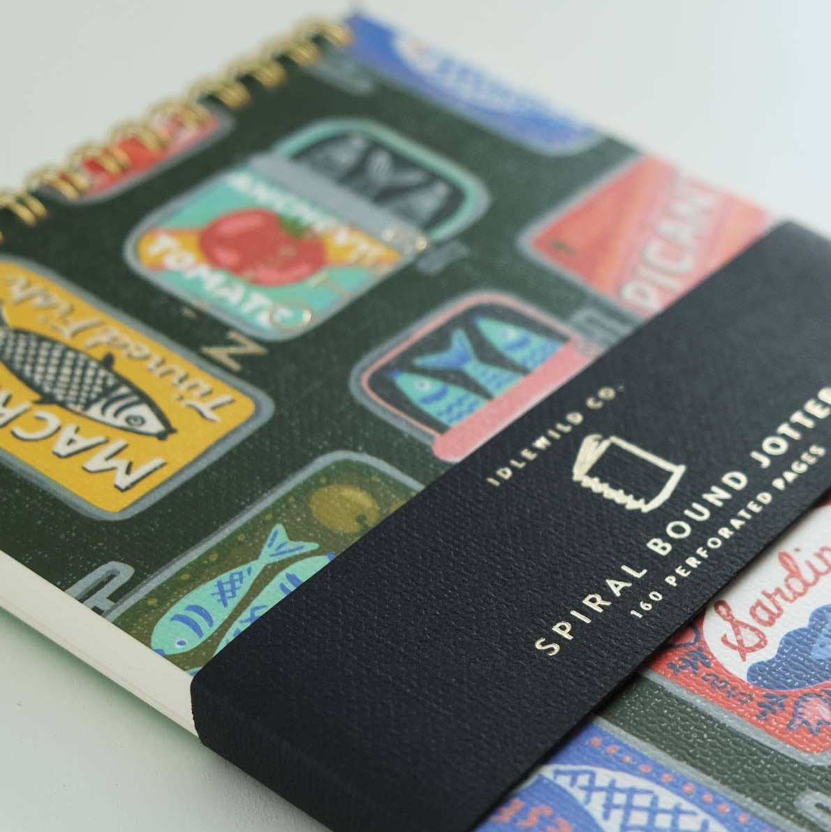 small, spiral, lined notebook with a hand painted tinned fish design