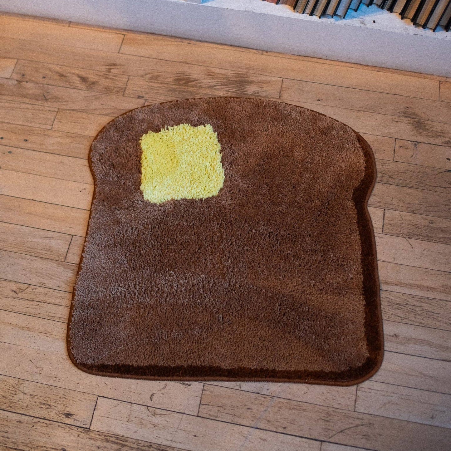 toast shaped rug with pad of butter on floor
