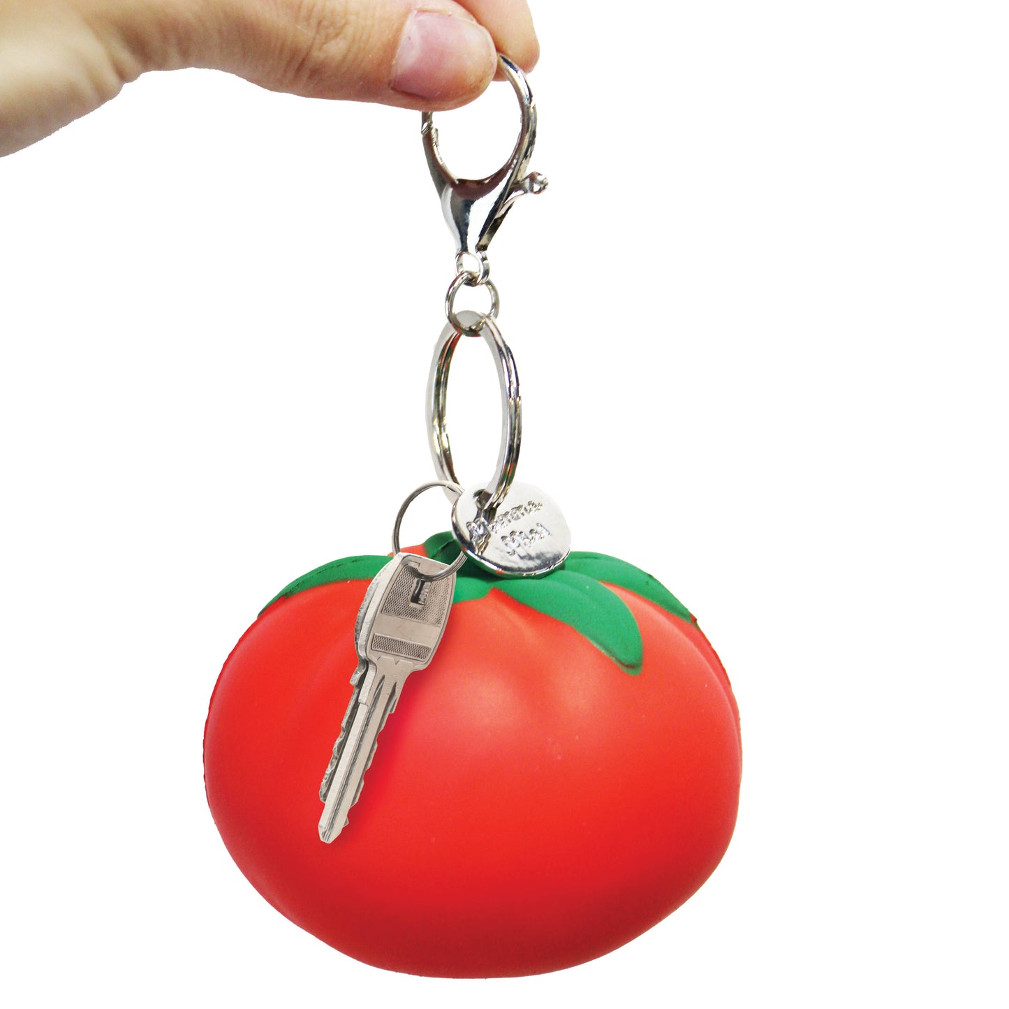 Stress ball keychain shaped like a tomato with a key attached, held by a hand against a white background.