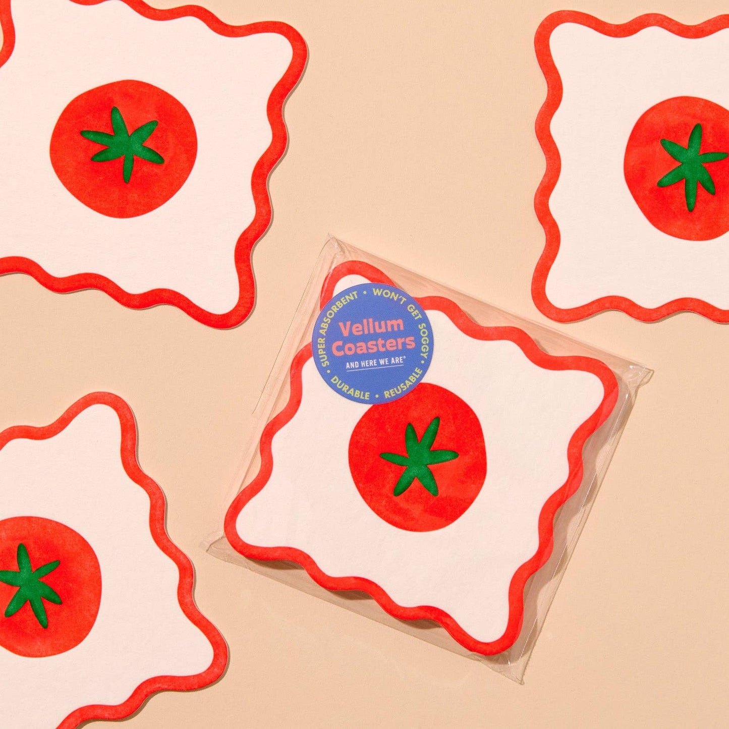 Vellum coasters with tomato design on a beige background