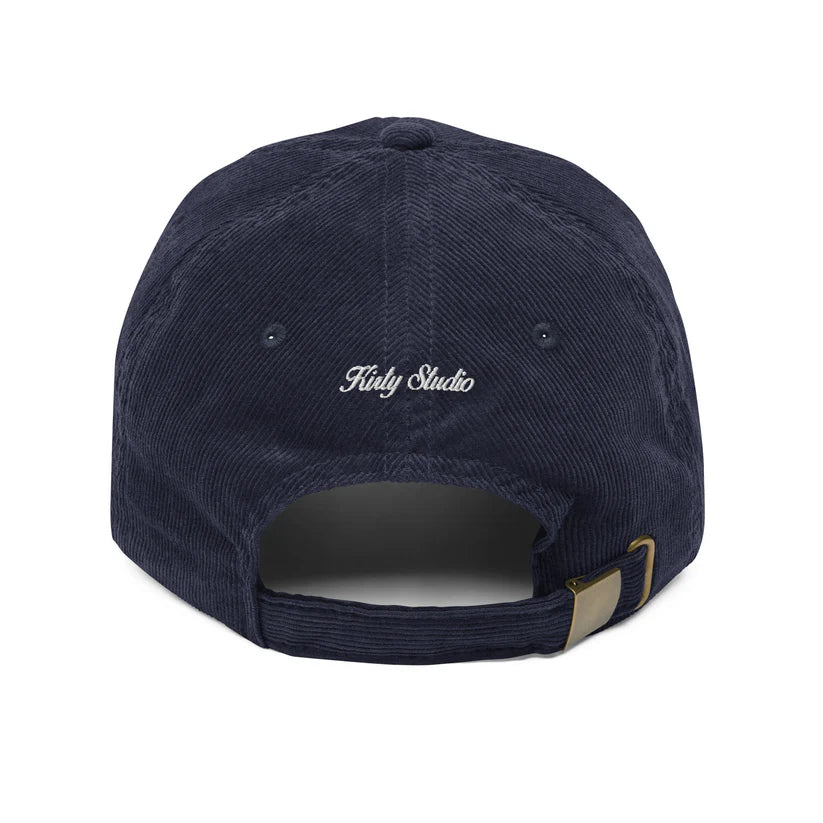 Navy blue cap with 'Kirty Studio' embroidery on a white background