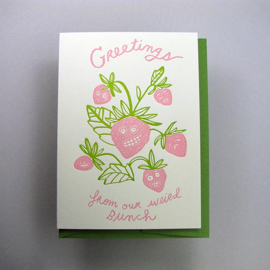 Greeting card that reads "Greetings from our weird bunch" with an illustration of a strawberry bunch with different silly faces on them