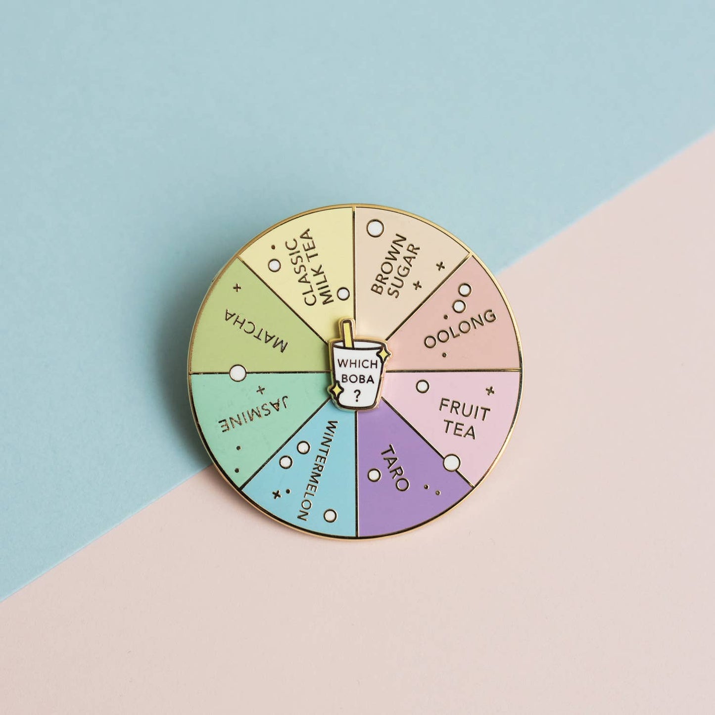 Colorful enamel pin with boba/bubble tea flavor options on a pastel background