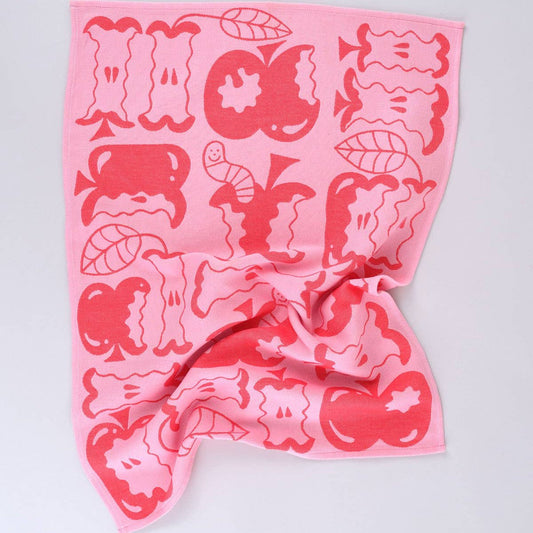 red and pink kitchen towel "an apple a day" designed with bitten apples and worms coming out of them