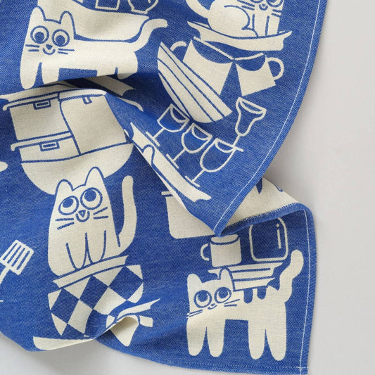 corner view of the blue and white "kitchen cats" tea towel