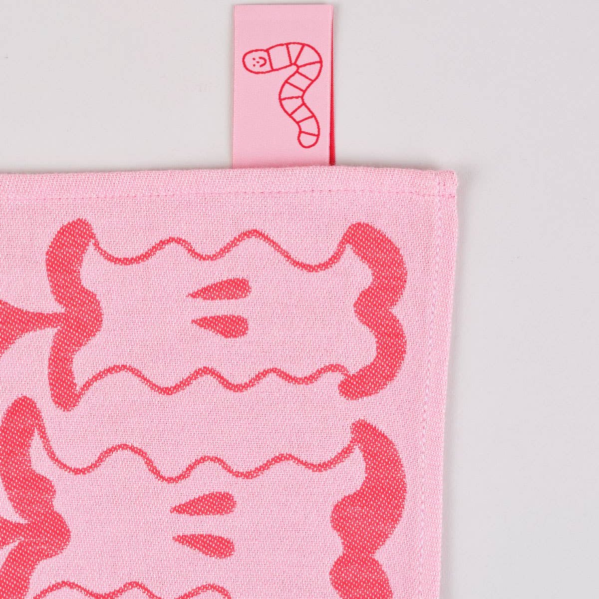 image of the corner and product tag of "an apple a day" kitchen towel