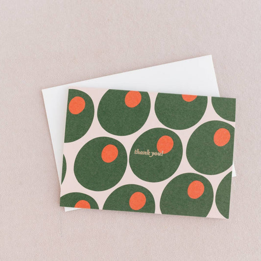 Thank you card with the words in gold foil. Pattern of green olives stuffed with pimentos. White envelopes.