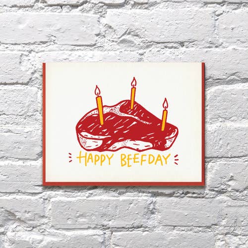 Birthday steak greeting card -- steak with birthday candles in it, text reads "Happy Beefday"