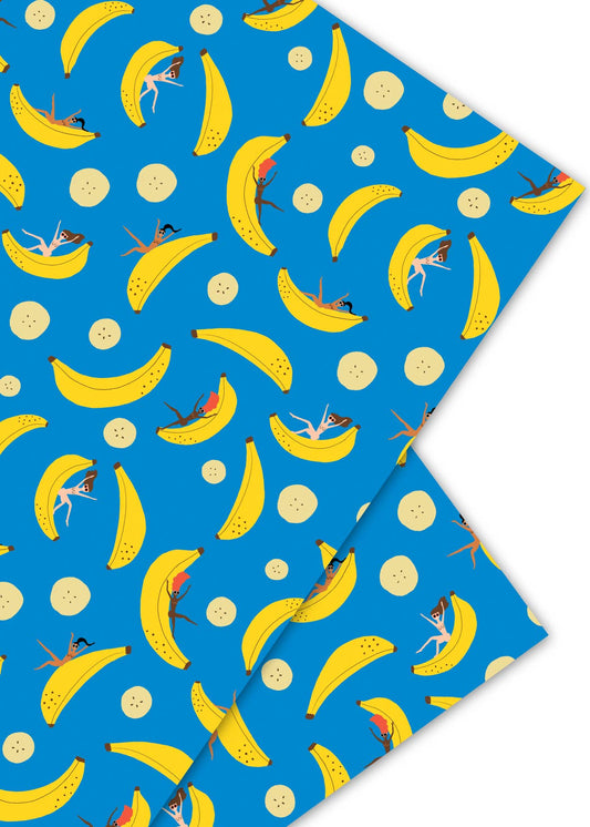 Single sheet of wrapping paper --- design is blue with both sliced and whole bananas on it with women in bikinis sliding down the whole bananas.
