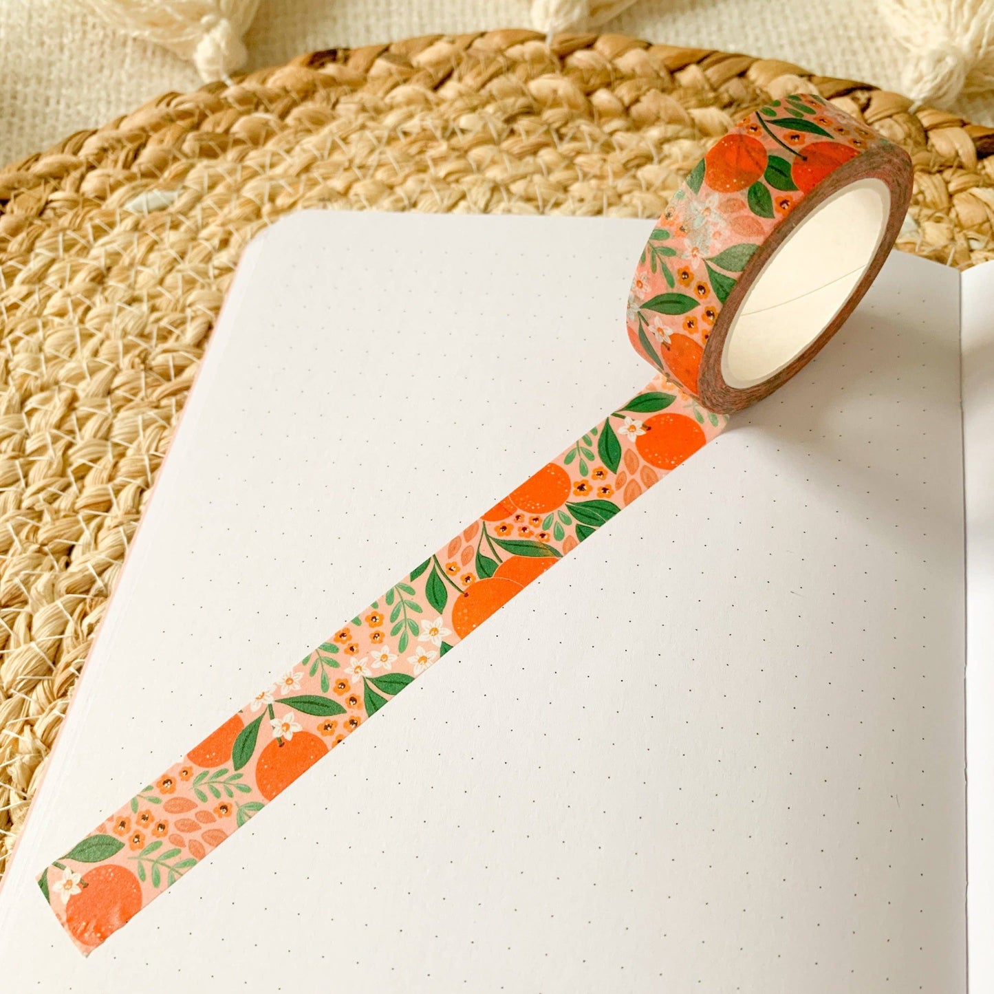 Roll of washi tape with oranges, florals and foliage as the design