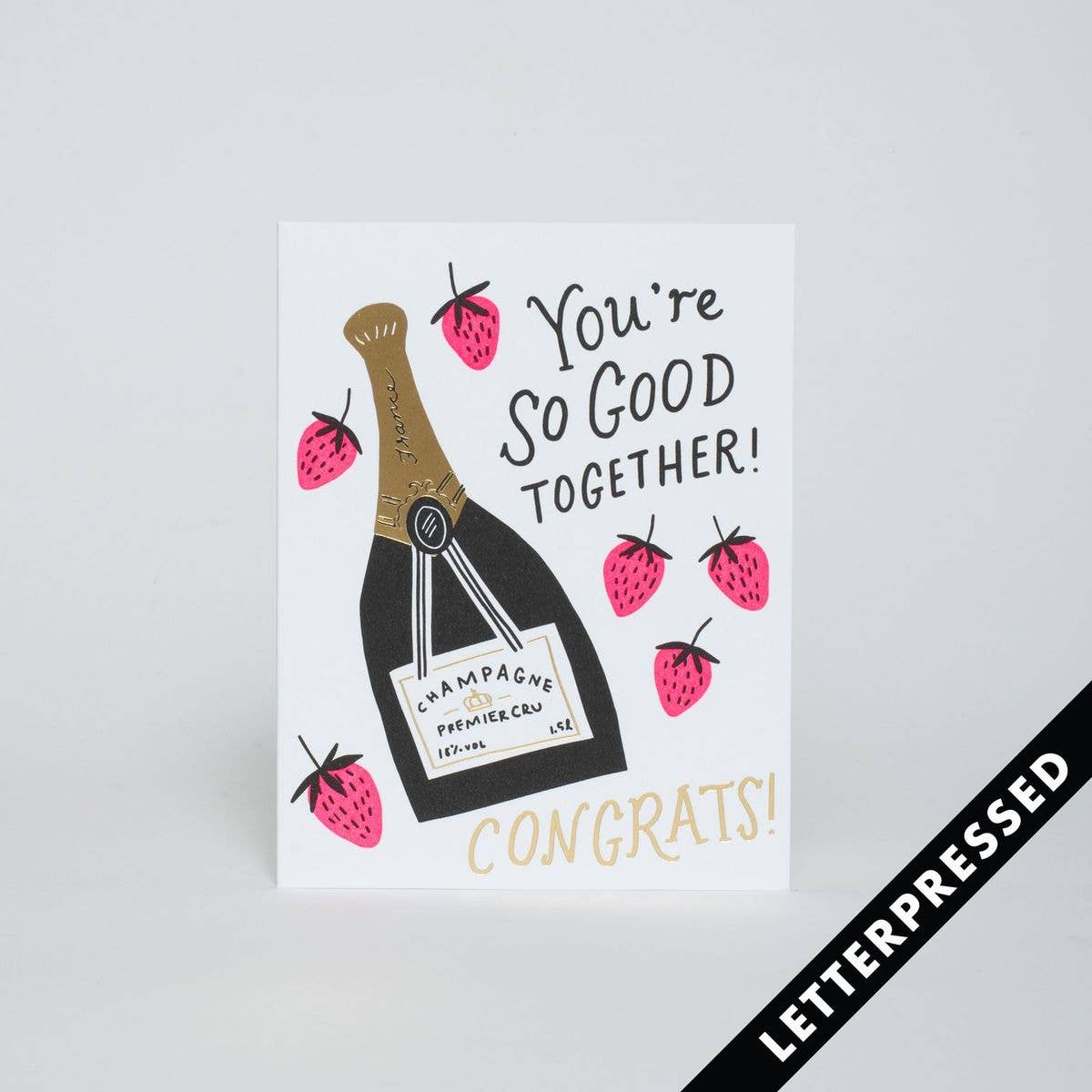 Greeting card that reads "You're so good together! Congrats!" and has a bottle of champagne with strawberries on it