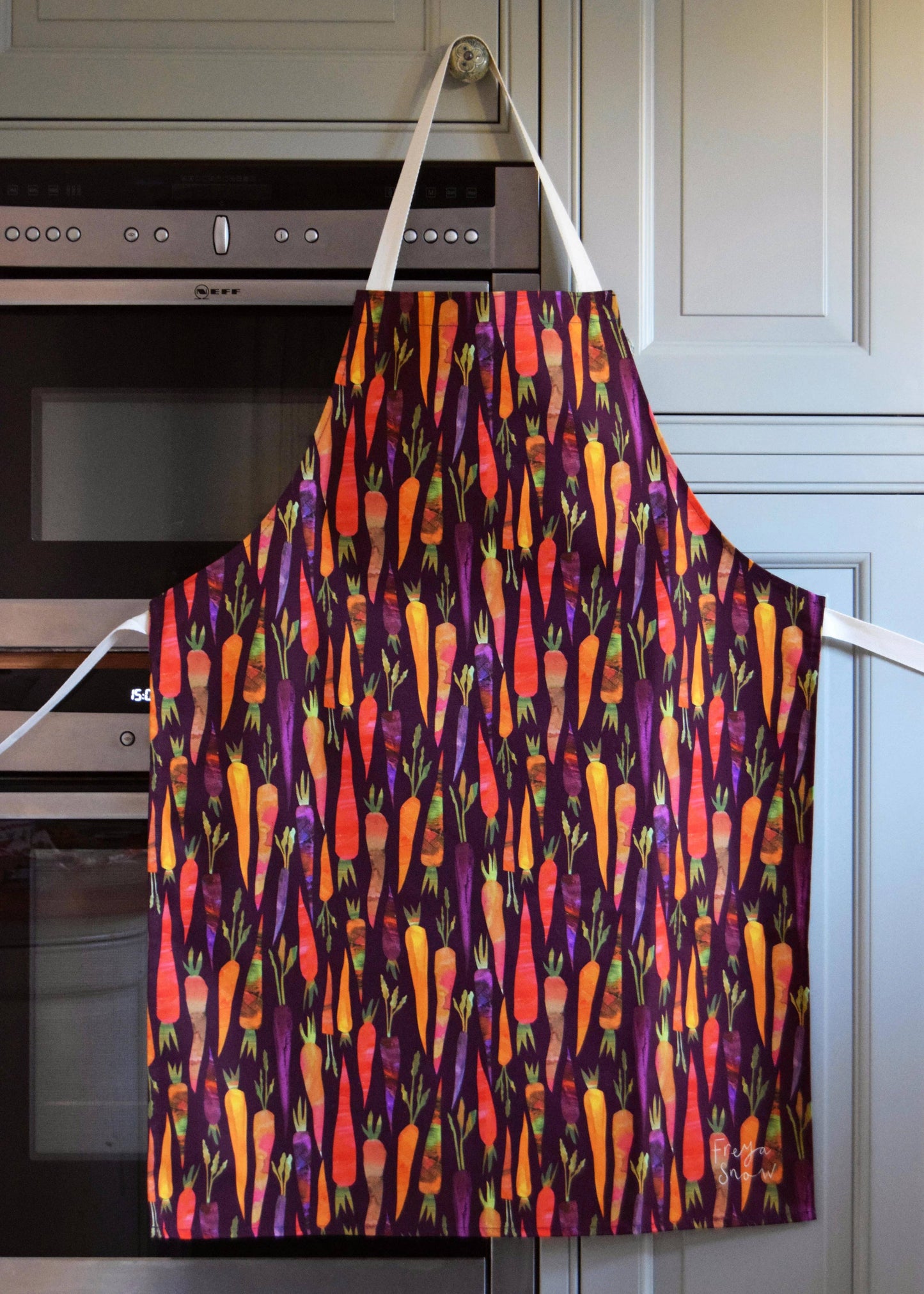 Adult size purple apron with rainbow carrots all over