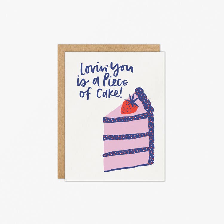 Love-cake-greeting card -- has a slice of blue and purple cake on it with a strawberry on top and reads "Lovin' you is a piece of cake"