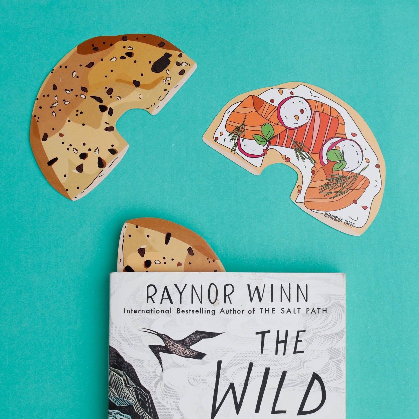 Doublesided bagel (cut in half) bookmark -- one side is the top of the bagel, the other side is inside of a bagel with cream cheese, lox, radishes and dill.
