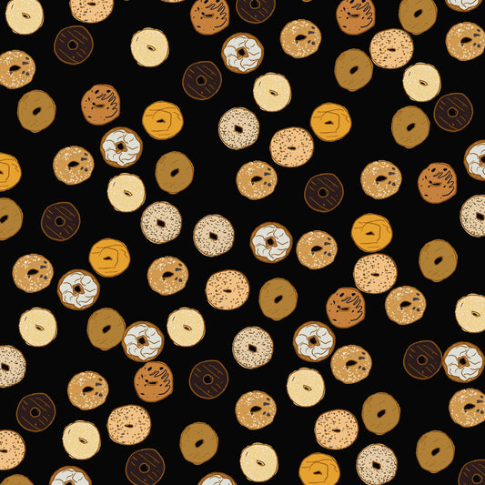 assorted bagels on a black background. This is a sheet of wrapping paper with the signature La Familia Green on the bottom.