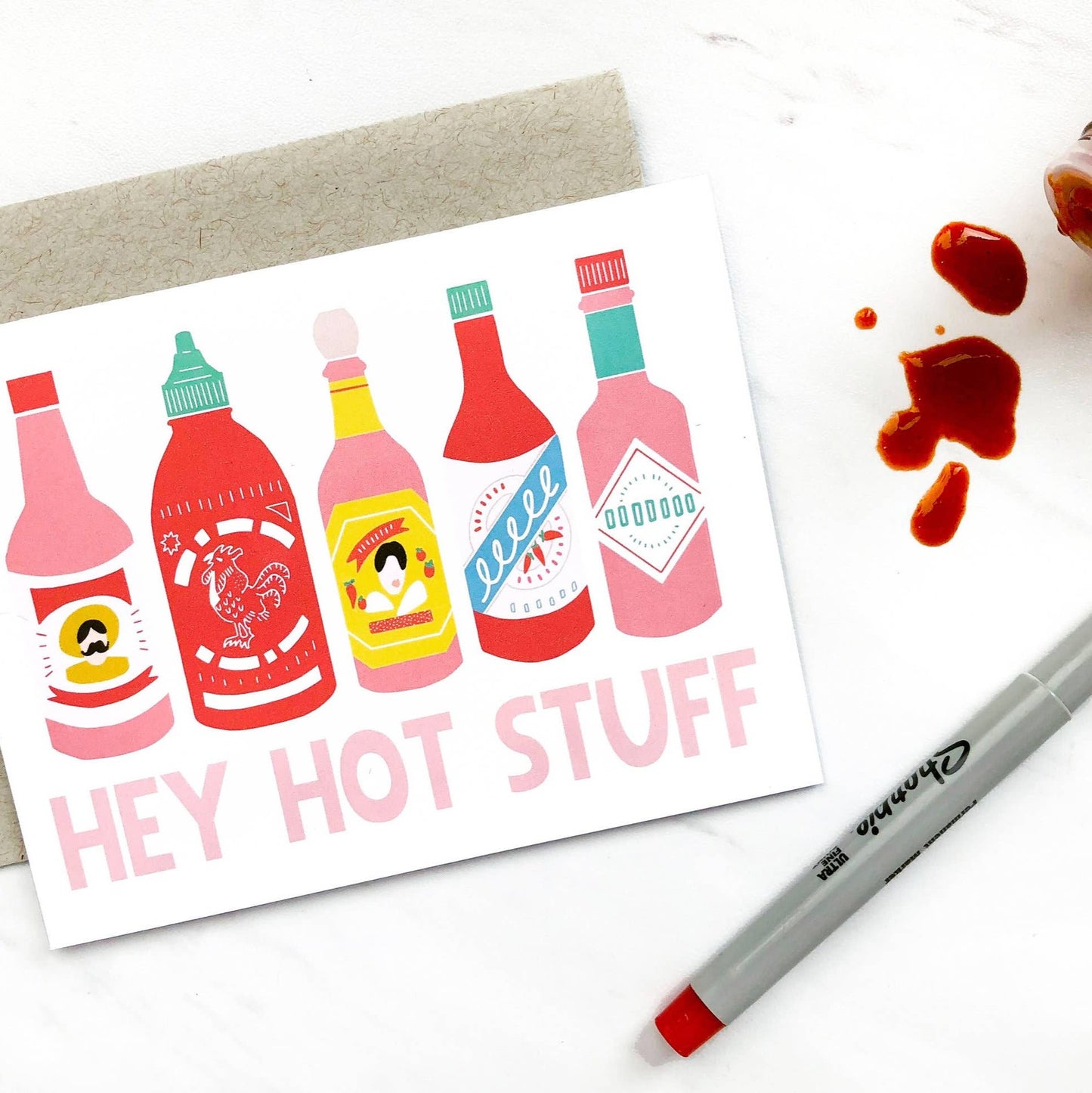 Greeting card that has 5 different hot sauce bottles on it and reads "Hey Hot Stuff"