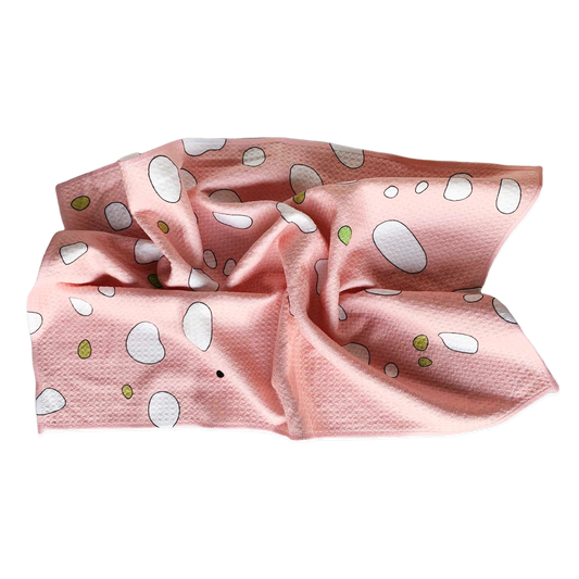 Kitchen towel with a mortadella pattern all over -- pink background with green and white blobs throughout.