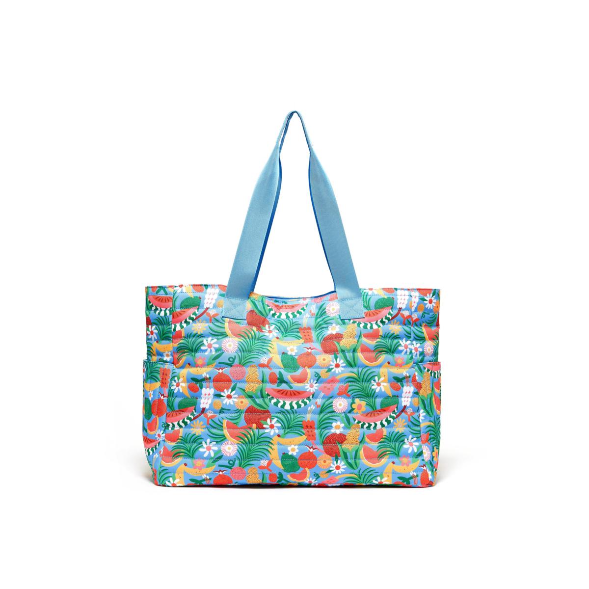 large tote bag with a light blue handle. Bag rotary print are various fruits with foliage, all on a light blue background